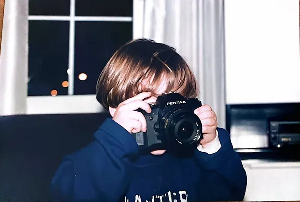 Vasilis Daskalakis as a child holding a camera